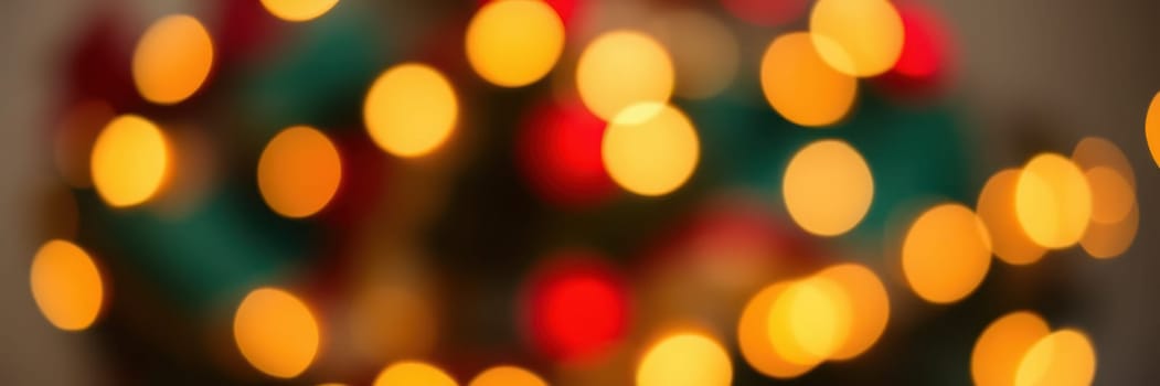 Glowing lights in red, yellow, and green create a cozy and festive atmosphere, evoking the spirit of the holiday season during a winter celebration.