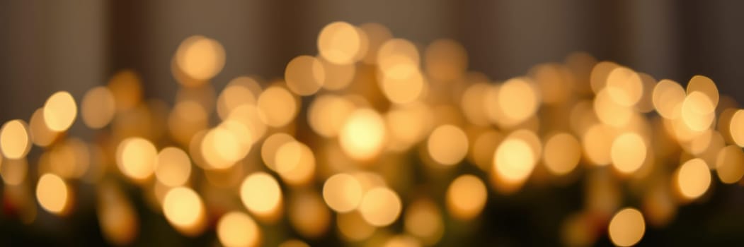 Soft golden lights illuminate a decorative space, enhancing the ambiance for a festive gathering. The warm glow creates a welcoming and inviting environment during the evening.