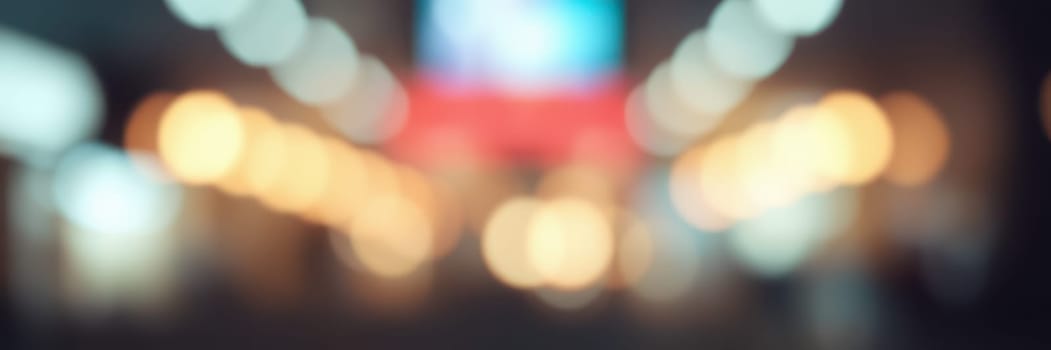 Bright lights illuminate the city streets during nighttime, creating a vibrant atmosphere filled with energy and excitement as people enjoy the lively environment.