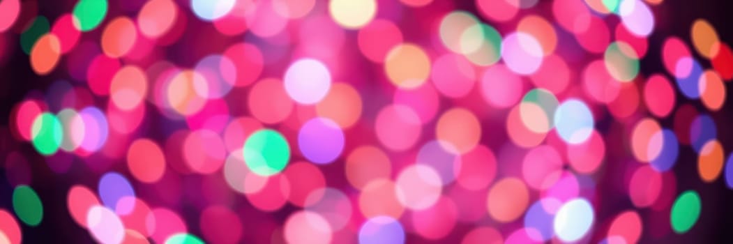 Brightly colored bokeh lights illuminate the surroundings, creating a festive and joyful atmosphere as people gather to celebrate in the evening.