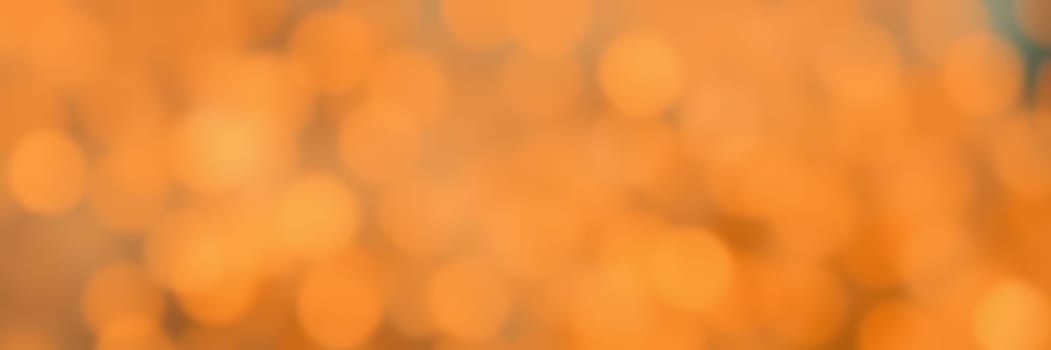 Soft, warm orange lights create a cozy ambiance, enhancing the inviting atmosphere of a gathering during the evening. A focal point for social interaction is evident.