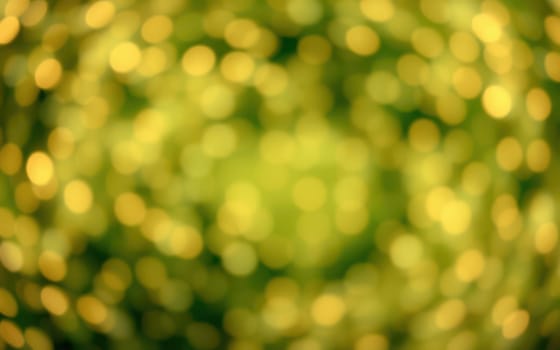 Vivid bokeh lights in green and gold blend together, creating an abstract background filled with soft circles of varying sizes. The shimmering effect adds depth and elegance.
