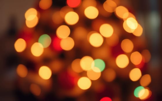 Colorful lights create a warm, festive atmosphere as they twinkle on a beautifully decorated Christmas tree, filling the cozy living room with holiday spirit and joy.