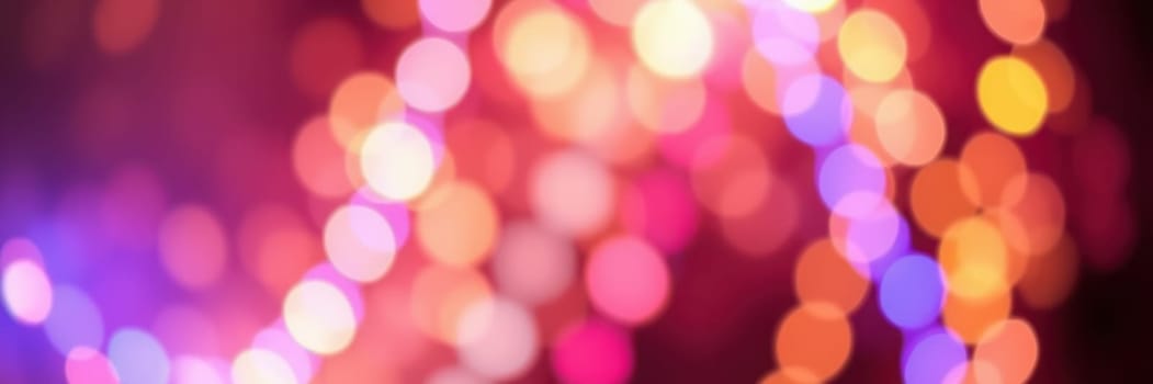 A dazzling array of colorful bokeh lights fills the background, creating a festive atmosphere perfect for celebrations. The lights shimmer in various hues, enhancing the joyful mood.