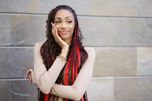 A confident woman with vibrant and eyecatching hair poses elegantly against a sleek, modern backdrop, radiating style and charm, showcasing her remarkable selfassurance and distinct individuality