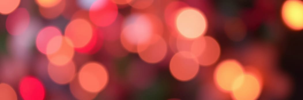 colorful bokeh lights illuminate the surroundings, creating a joyful ambiance in a city park during an evening event that attracts many visitors.