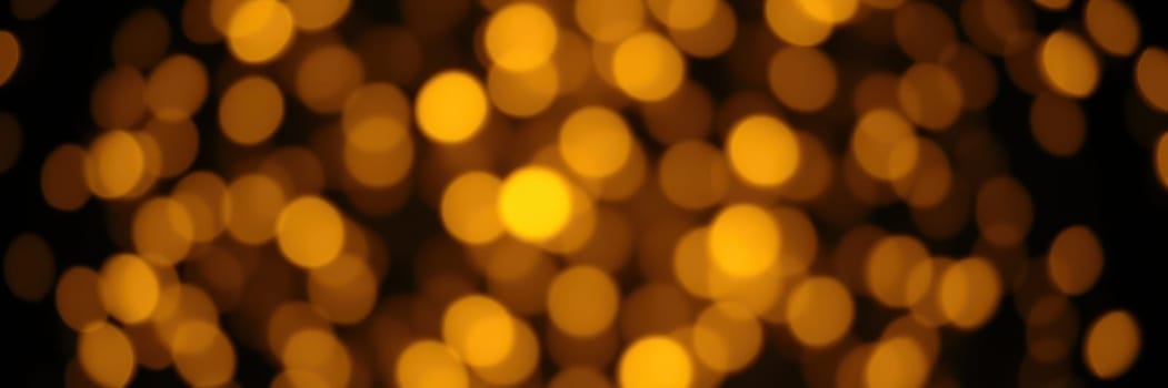 Soft golden bokeh lights illuminate the surroundings, creating a cozy atmosphere perfect for a festive gathering or celebration at night.