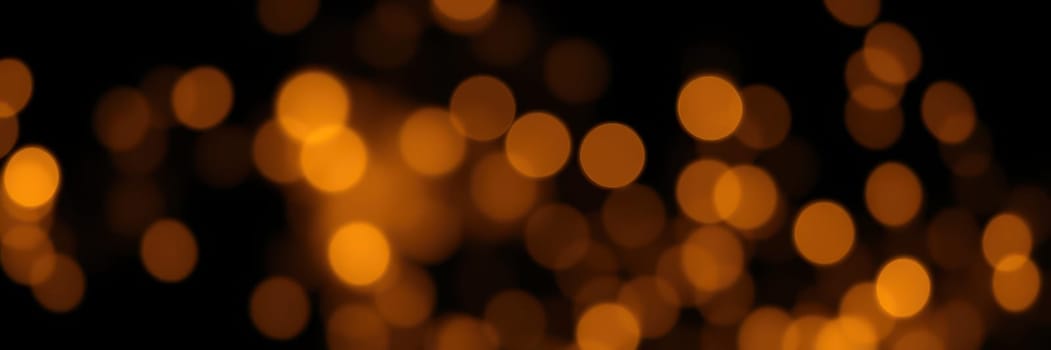 Glowing golden bokeh lights shimmer beautifully against a dark backdrop, enhancing the enchanting atmosphere of a night celebration filled with joy and warmth.