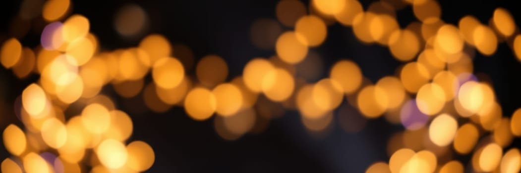 Bright, warm lights illuminate a gathering area filled with people enjoying the winter festivities. The ambiance is inviting, perfect for socializing and celebration.