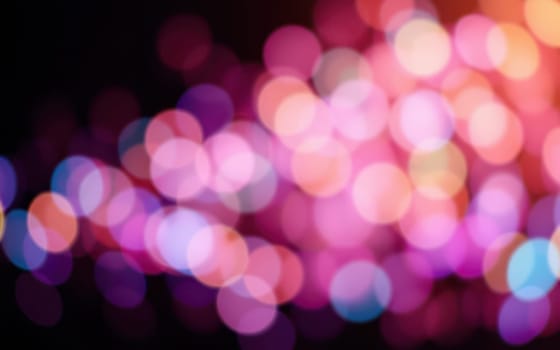 Colorful bokeh lights fill the background during a lively celebration at night, creating an enchanting atmosphere. Laughter and joy surround the gathering, enhancing the festive spirit.