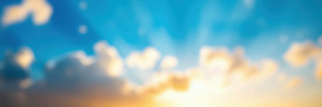 A stunning sunrise fills the sky with vibrant colors, illuminating clouds with golden and blue tones. The peaceful atmosphere suggests the promise of a fresh start.