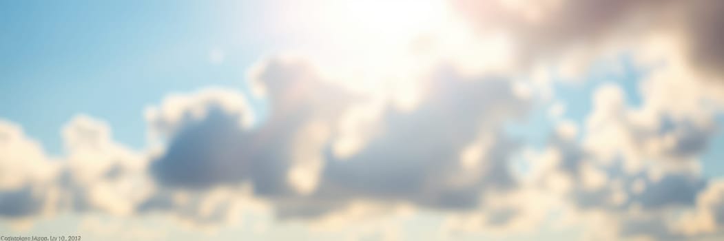 Soft clouds drift across a bright blue sky as sunlight shines through, creating a warm and inviting atmosphere perfect for outdoor activities.