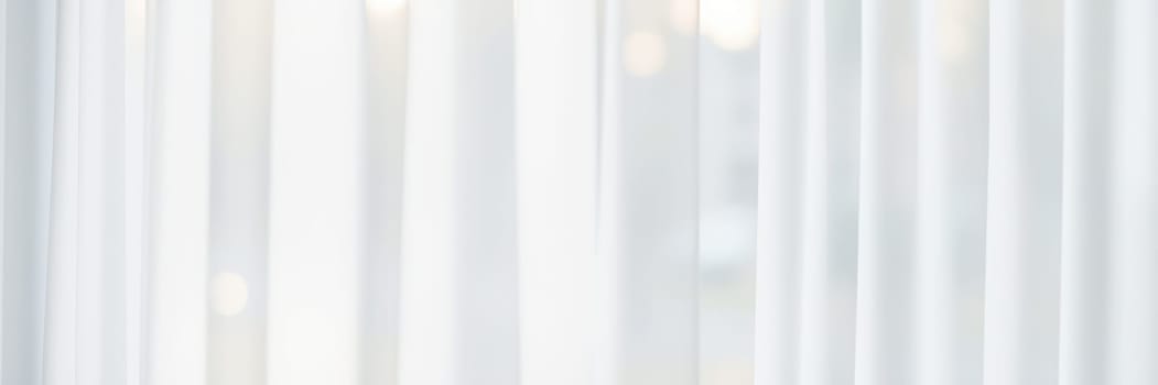 Soft sunlight streams through white sheer curtains, illuminating a calm indoor area, enhancing the tranquil ambiance and inviting relaxation during the day.
