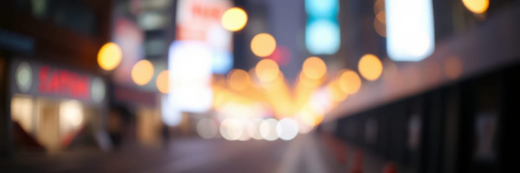 A busy city street comes alive at night with vibrant lights creating a festive atmosphere. People can be seen walking amidst glowing billboards and storefronts.