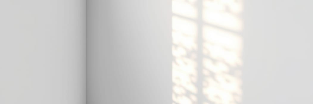 Soft rays of sunlight stream through the window, creating delicate shadows on the plain wall, adding a tranquil ambiance to the indoor space during morning hours.