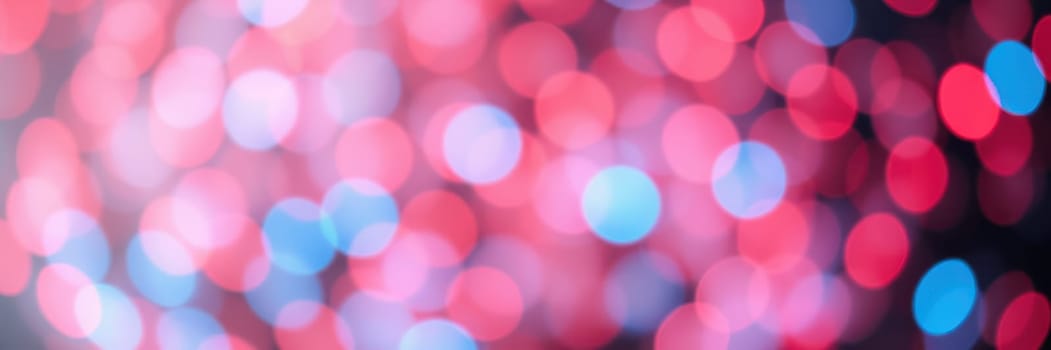 A collection of bright, soft-focus lights in various colors blends harmoniously, adding excitement and energy to a lively evening celebration filled with joy.