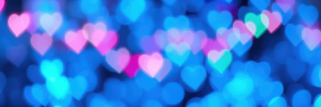 Bright heart-shaped lights in various colors illuminate a lively space, creating a romantic ambiance perfect for a festive gathering or celebration during the evening.