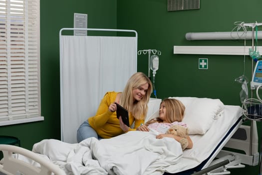 A touching and caring moment shared between a devoted mother and her beloved child within a hospital setting