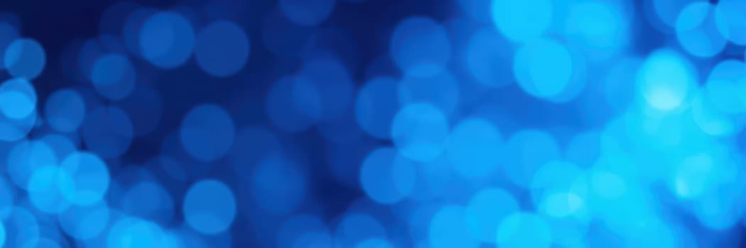 A colorful display of blue bokeh lights fills the background, creating a dreamy atmosphere. This enchanting scene captures the essence of a lively evening event, perfect for celebrations.