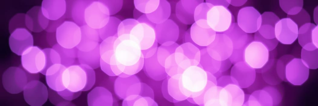 Soft purple bokeh lights illuminate the atmosphere at a lively urban evening event, creating a festive and enchanting ambiance for attendees to enjoy.