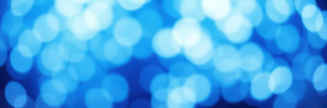 Soft blue bokeh lights fill the background, creating a tranquil and dreamy ambiance. The gentle glow invites a sense of calm and wonder during the evening hours.