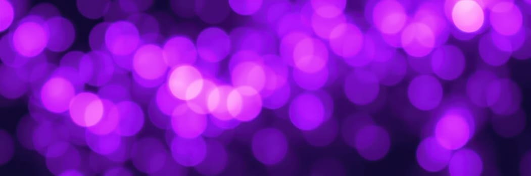 Bright purple lights form a captivating bokeh effect, enhancing the ambiance of nightlife. This enchanting display of colors sets a joyful mood for gatherings and festivities.