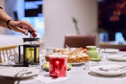 A beautifully arranged dining table, featuring delightful tea, delicious pastries, and an inviting cozy atmosphere