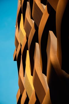 A stunning architectural detail showcasing dynamic curves and vibrant colors against a clear blue sky