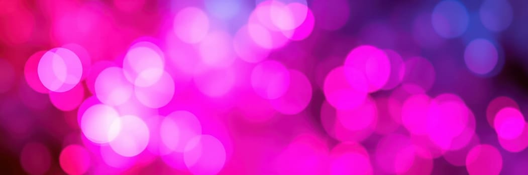 Bright pink and purple bokeh lights illuminate the surroundings, creating a lively atmosphere perfect for a festive celebration or an evening gathering in the city.
