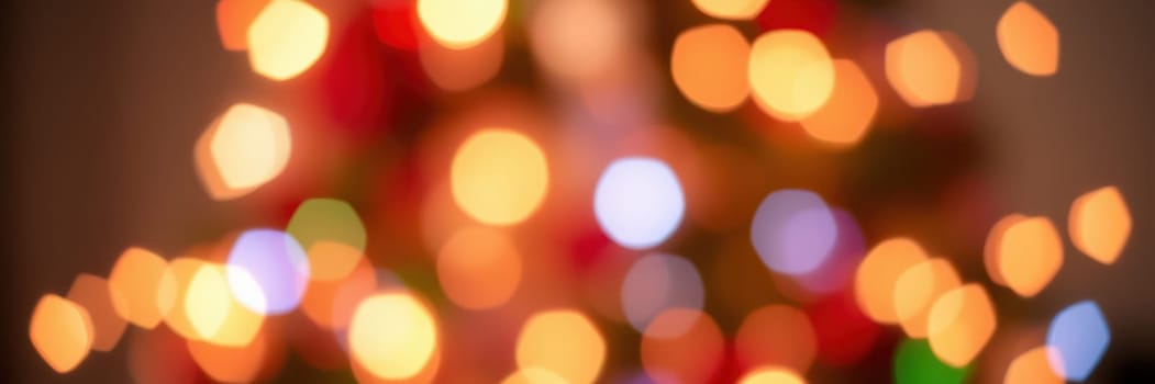 Warm, colorful lights twinkle softly in a cozy indoor space, creating a festive and inviting ambiance for the winter holiday season. The atmosphere is cheerful and bright.