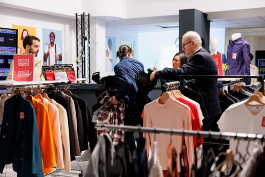 Black Friday madness. Crazy mad people shoppers standing in line with purchases in fashion boutique, shopaholic customers arguing and fighting over clothes in clothing store during seasonal sales