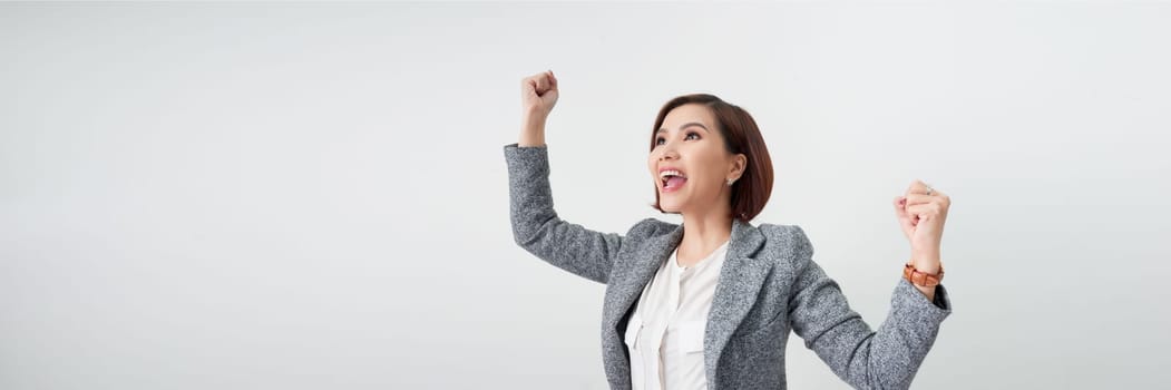 Successful business woman with arms up - isolated over a white background. banner