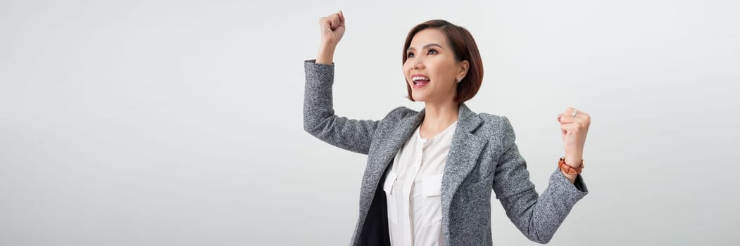 Successful woman with arms up celebrating on white banner