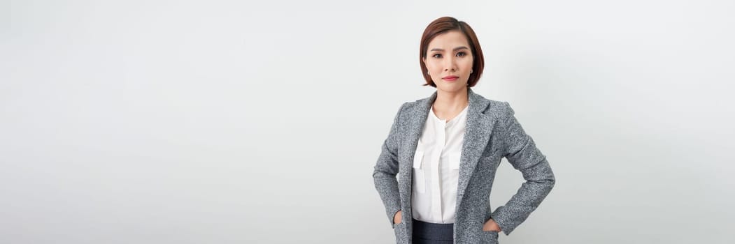 Young asian woman, professional entrepreneur standing in office clothing, smiling.