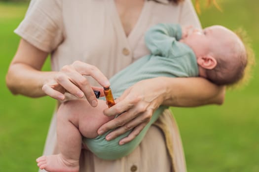 Loving mother gently applies soothing aroma oils to her precious newborn, creating a calming and nurturing atmosphere.