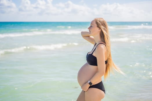 Radiant pregnant woman in a swimsuit, amid the stunning backdrop of a turquoise sea. Serene beauty of maternity by the shore.