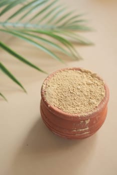 mixing brewers yeast flakes in a container on table .