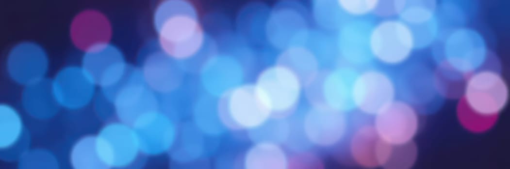 Soft and vibrant bokeh lights illuminate the dark surroundings, adding a magical touch to evening festivities. The colorful spots create a joyful ambiance perfect for gatherings.