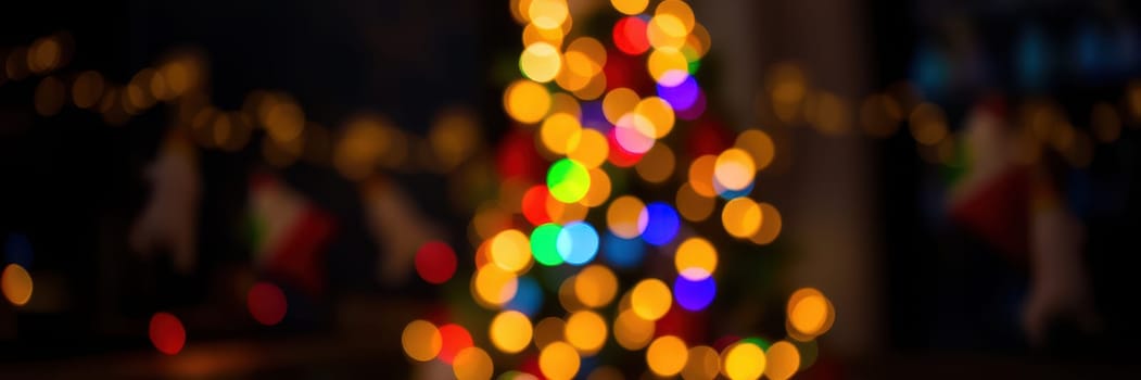 Bright bokeh lights decorate a Christmas tree, creating a joyful atmosphere. Colorful orbs of light twinkle in a lively, festive setting at night.