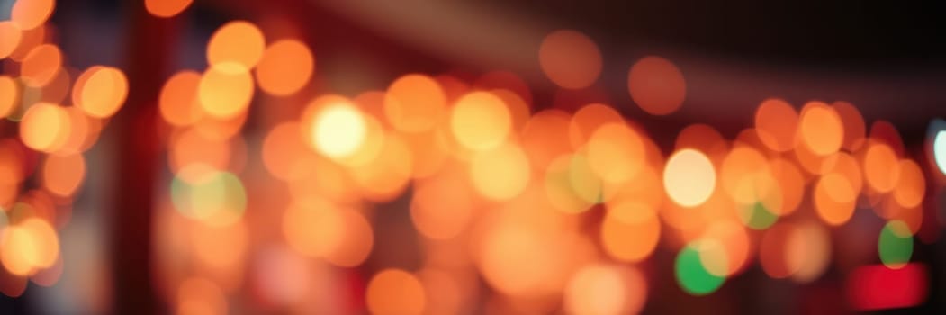 Twinkling warm lights illuminate a vibrant space filled with festive decorations and joyful activity. People enjoy the festive ambiance, celebrating together during the holiday season.