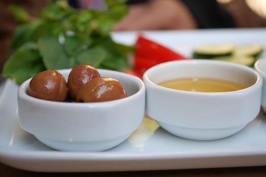 A vibrant array of colorful appetizers with delectable dips and fresh, aromatic herbs