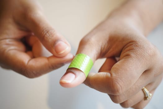 adhesive bandage on hand close up .