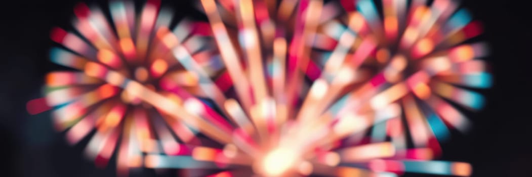 Bright bursts of fireworks illuminate the night sky, creating a spectacular show of colors. The atmosphere is festive, capturing the joy of the celebration.