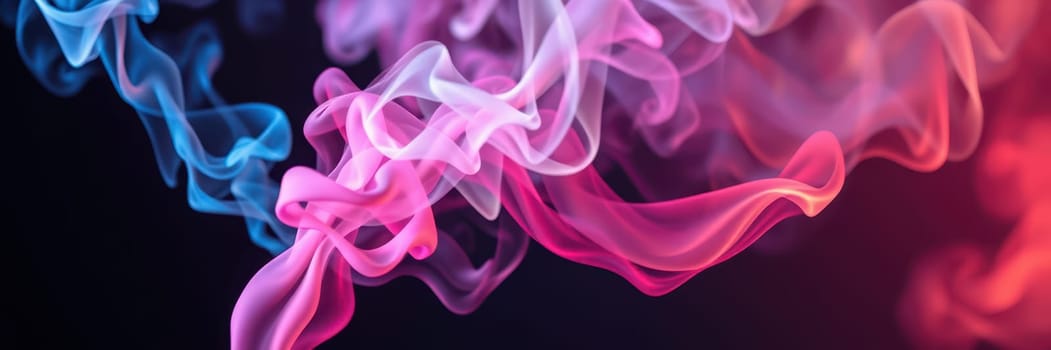 Artificially colored smoke swirls gracefully in vibrant shades of blue, pink, and purple against a dark background. The mesmerizing movement showcases artistic expression.