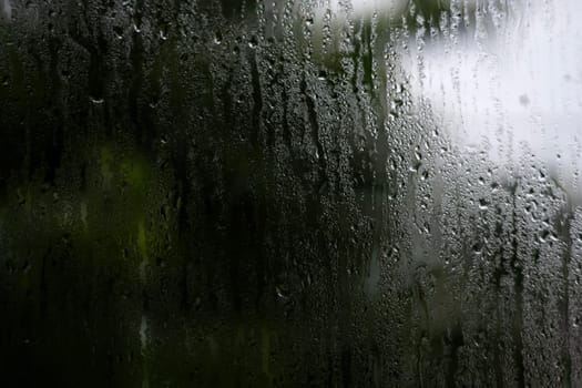 Raindrops on the glass outside the window.