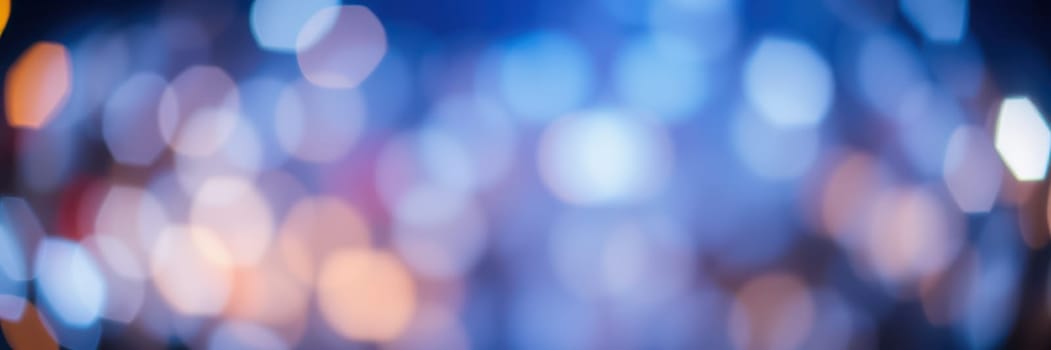Vibrant bokeh lights illuminate the backdrop of an evening gathering, adding a magical touch to the festive atmosphere as people mingle under the colorful glow.