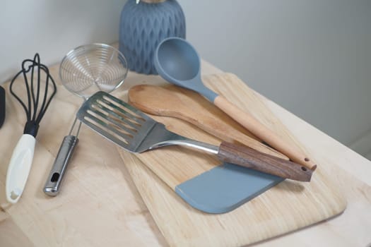 A variety of essential kitchen tools, like a spatula and whisk, organized neatly