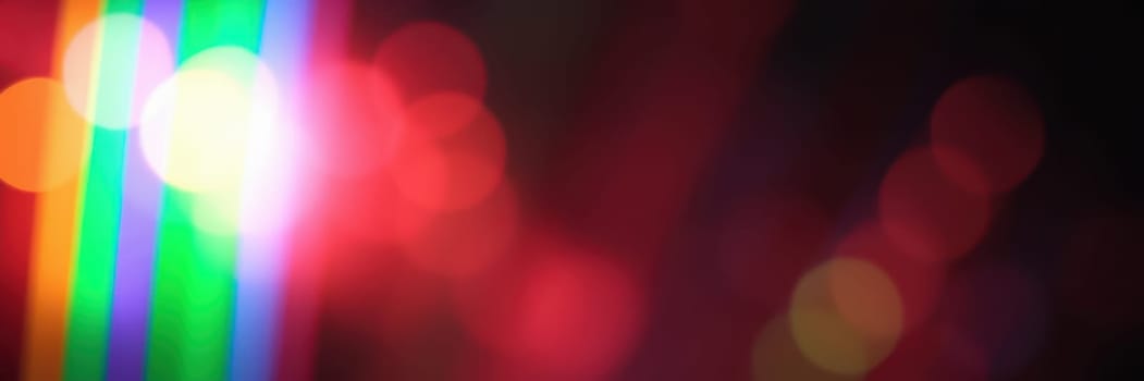 Bright lights create stunning patterns in various colors, showcasing an artistic arrangement at a lively nighttime event in the city, enhancing the festive atmosphere.