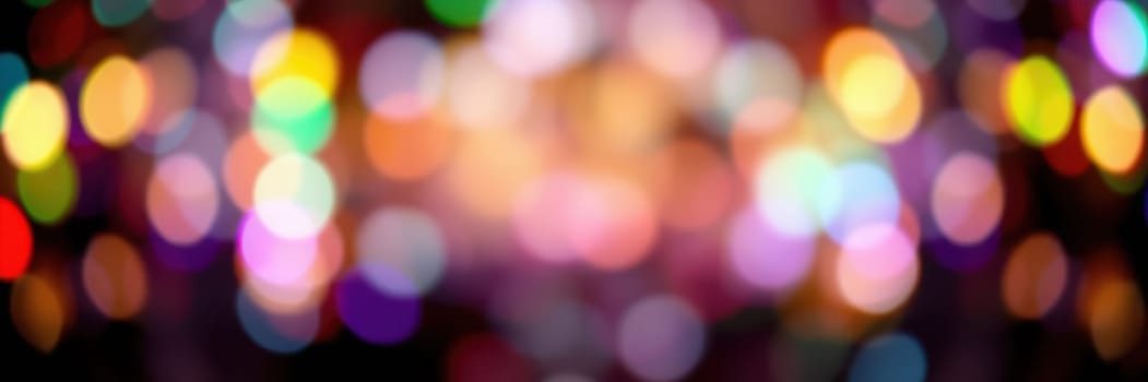 Bright and vibrant bokeh lights illuminate the surroundings, creating a joyful ambiance at a night festival. The colorful orbs enhance the celebratory mood in the urban setting.