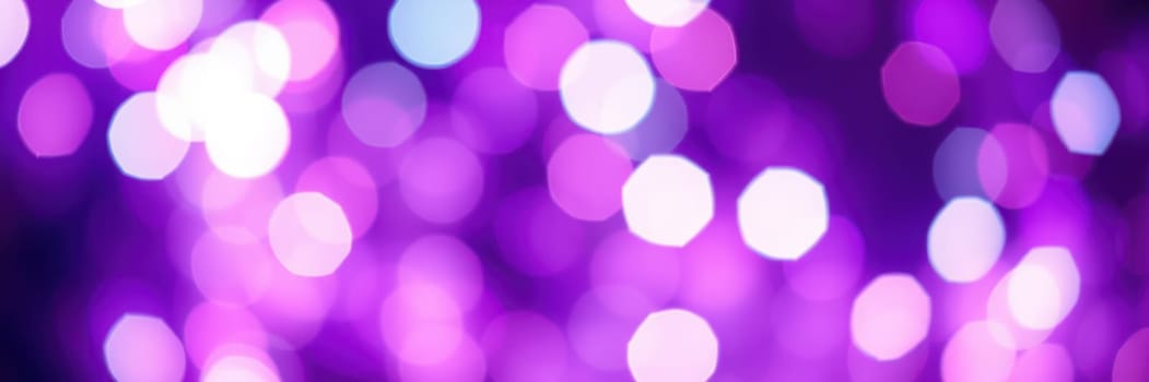 A multitude of purple and white bokeh lights create a magical ambiance during an evening event in an urban setting. People enjoy the festive atmosphere together.